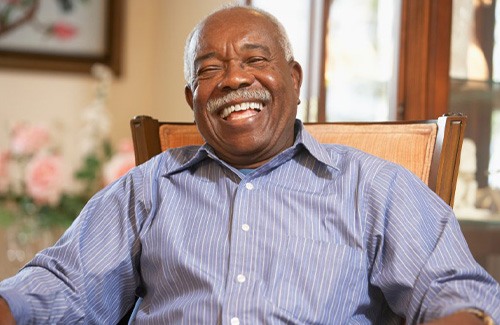 Man smiling brightly in his home