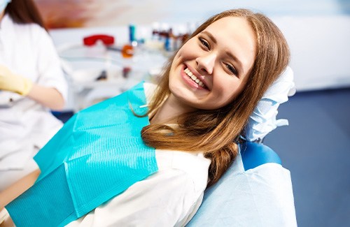 A woman smiling in a dental chair