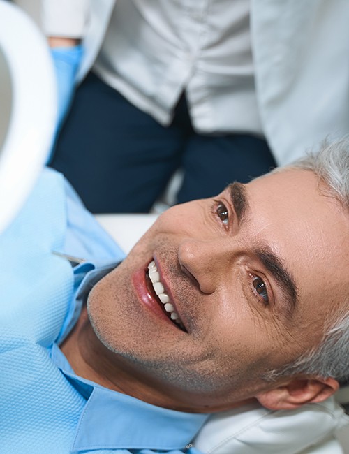 a patient smiling and admiring his new dental filling