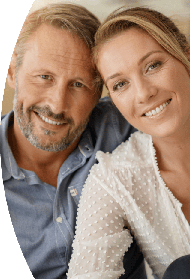 Man and woman with healthy smiles after restorative dentistry