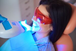 Woman doing an in-office professional teeth whitening treatment