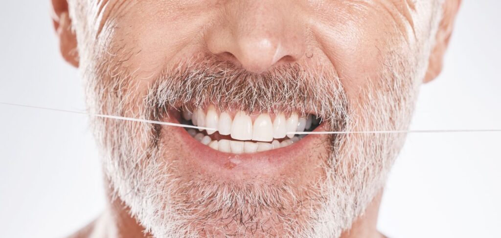 A man flossing his teeth